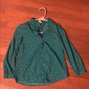 a buttoned down shirt with birds on it